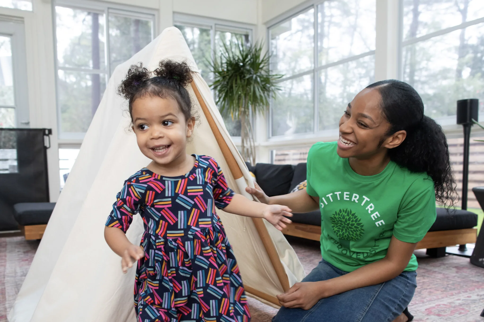 A sitter and child reduce screentime by building an indoor fort.