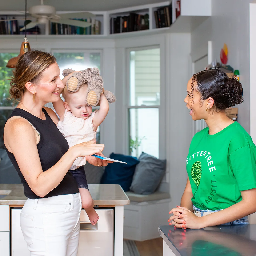 Mother with child talking to sitter
