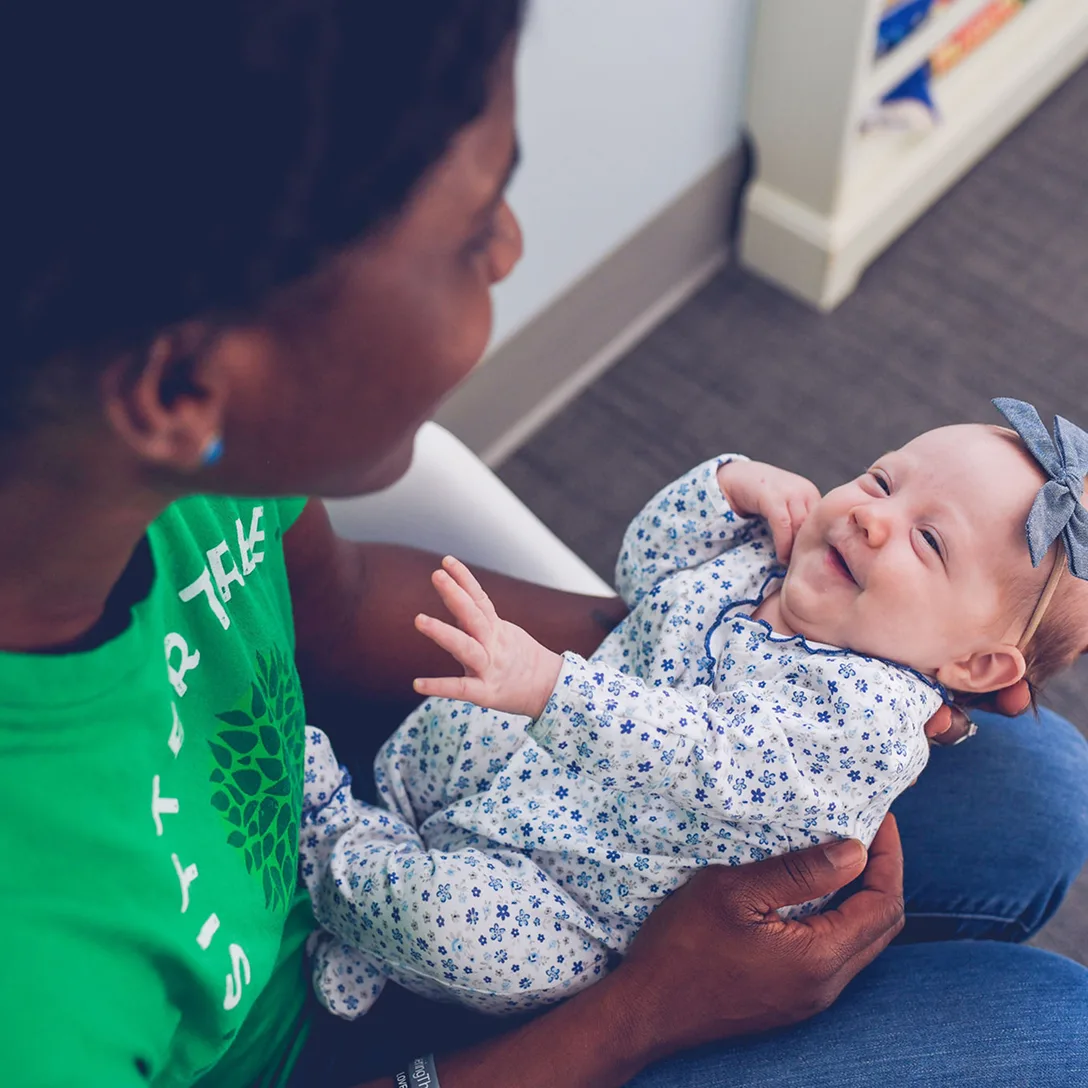 Babysitter holding a baby