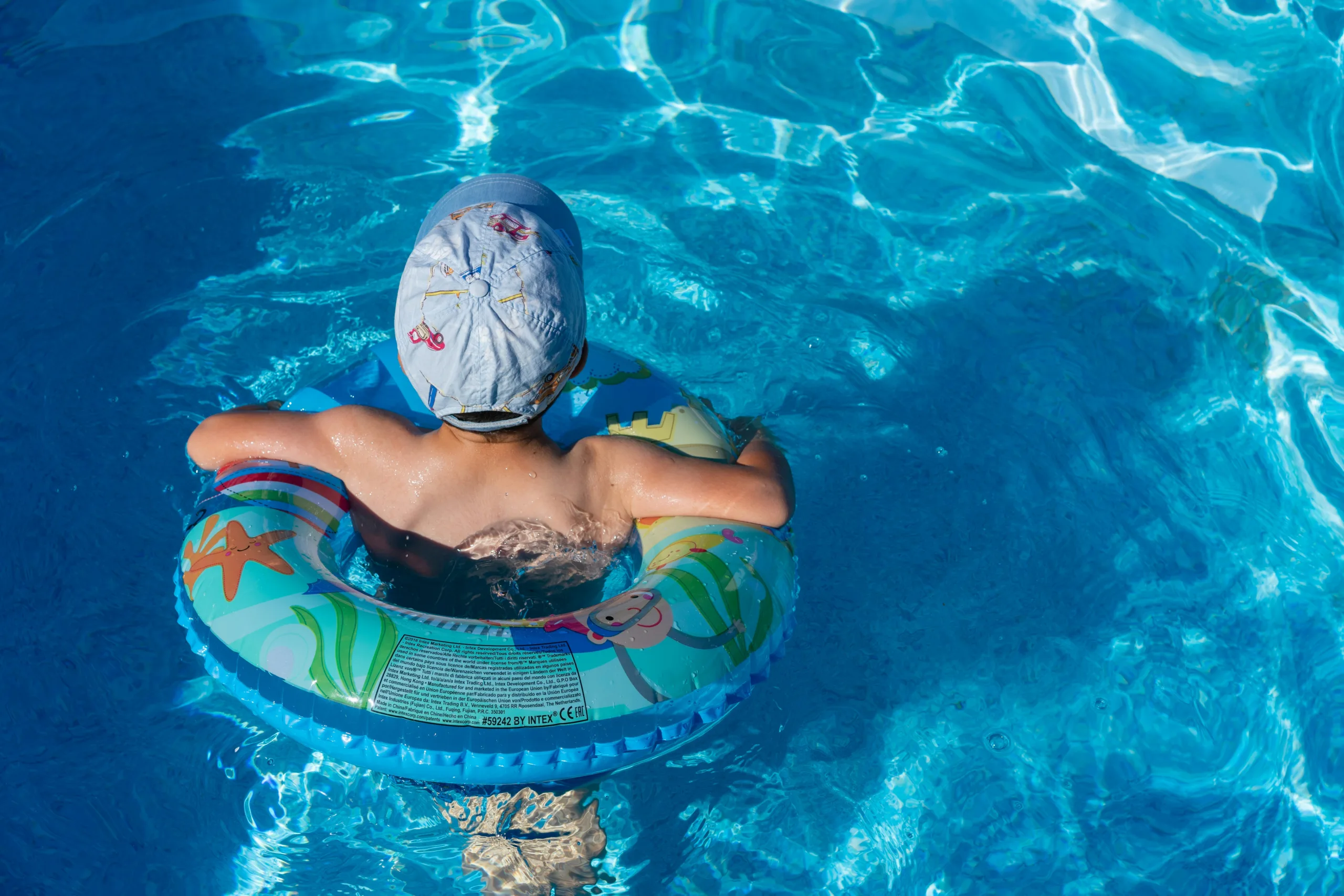 Child in pool in swim raft