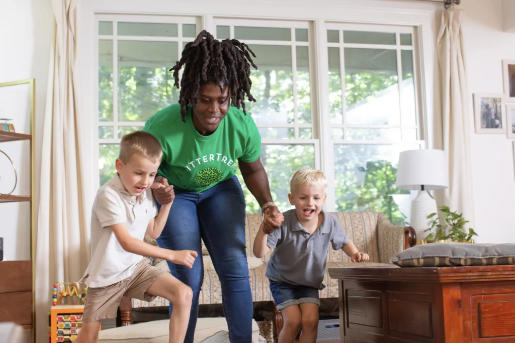 Sitter playing jumping game with kids