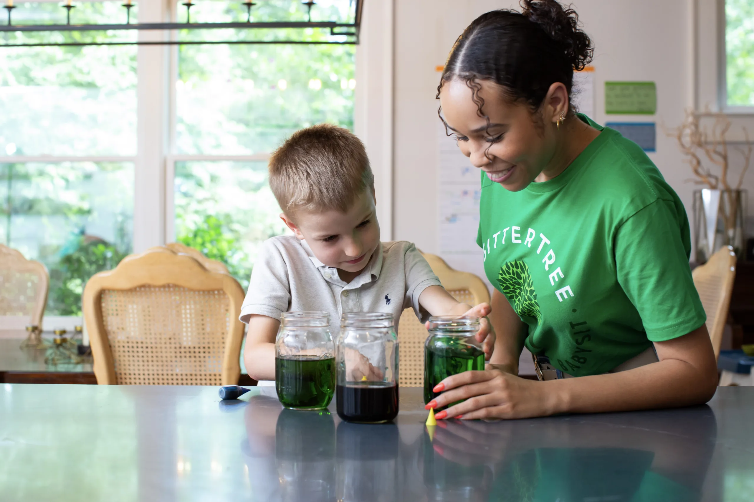 Sitter doing science experiment with child