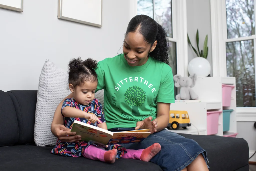 New babysitter reading book with child