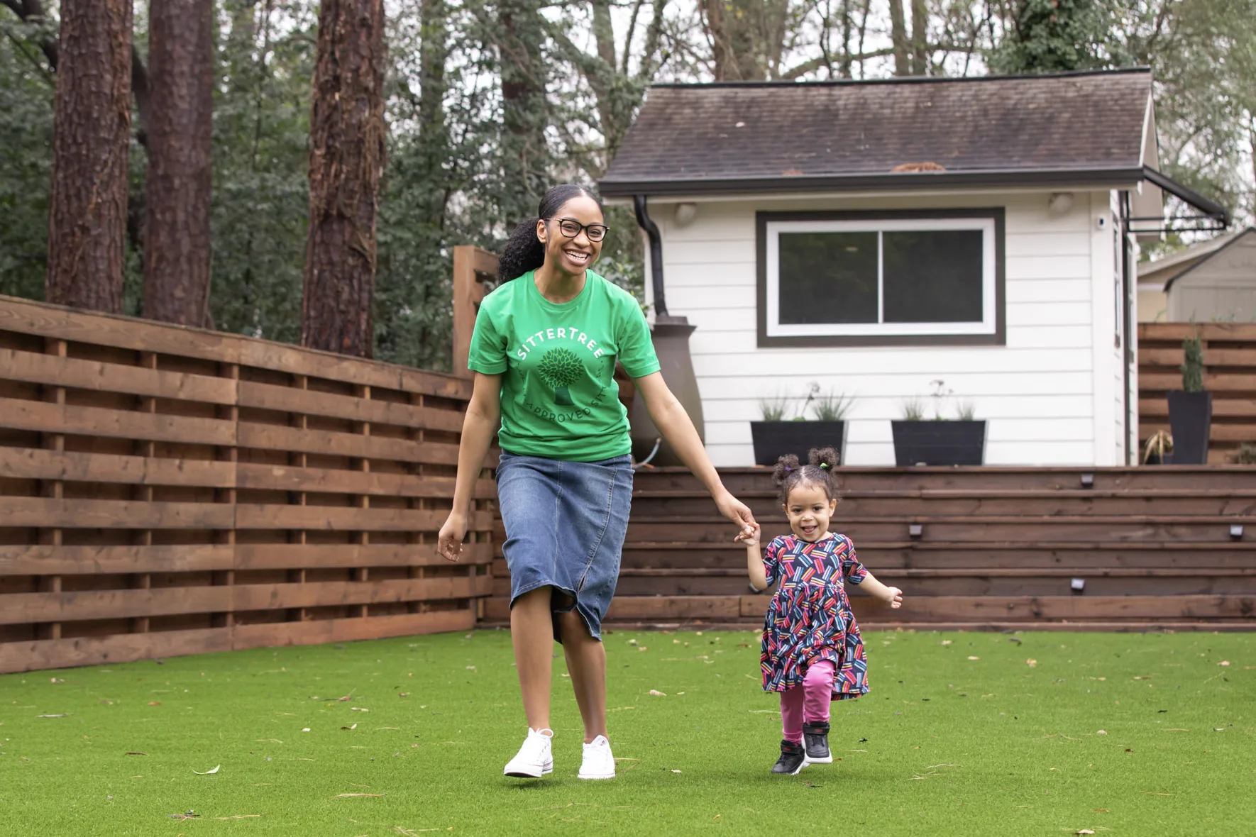Babysitter with child in backyard