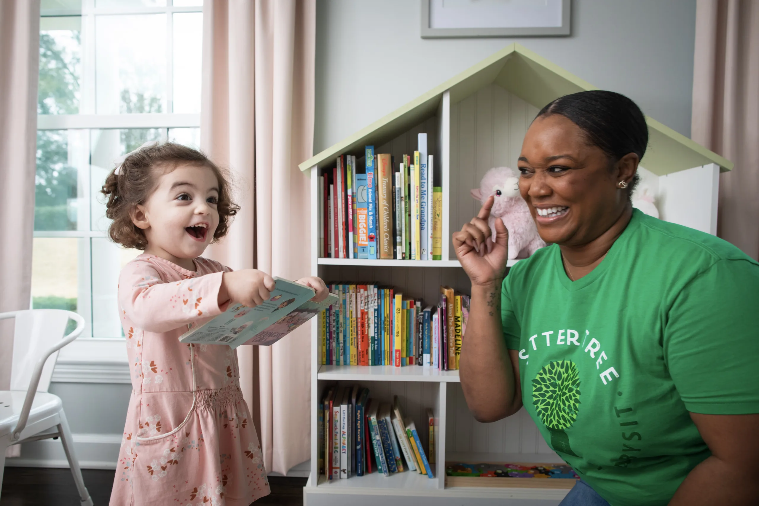 Child with book and babysitter